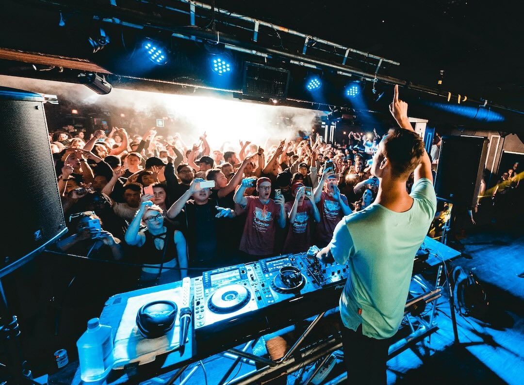 dj on stage in front of a crowd