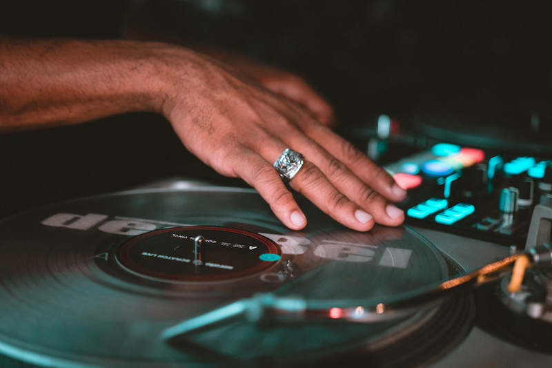 dj - hand scratching a record on a turntable