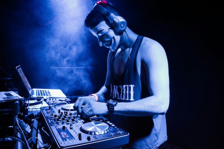 masked dj on a controller setup